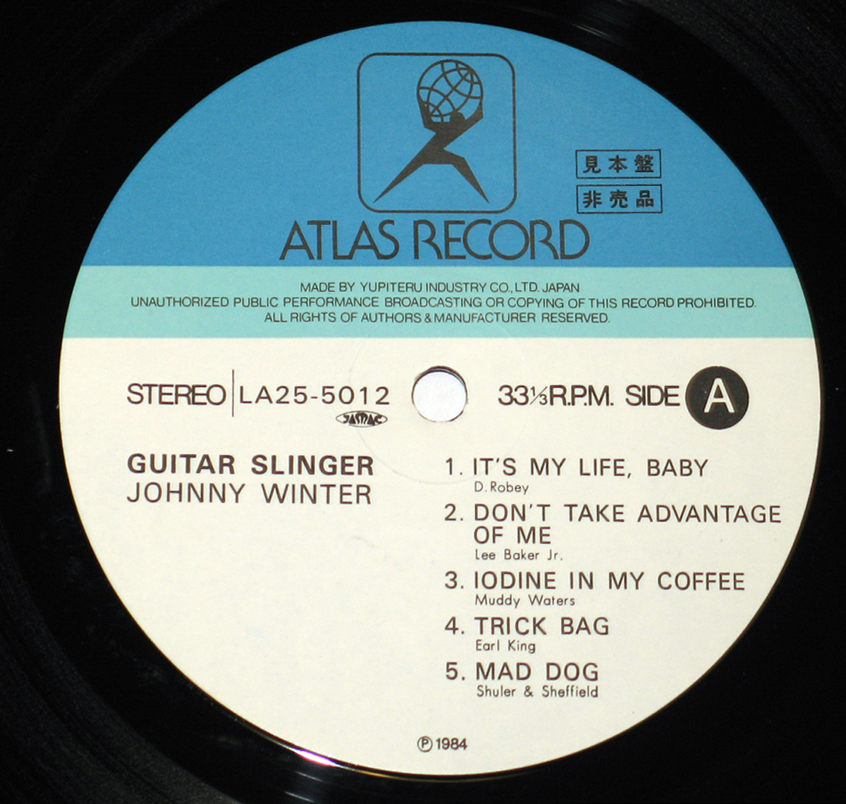 Close up of Side One record's label "JOHNNY WINTER - Guitar Slinger Japanese Release" Record Label Details: ATLAS Record Stereo LA25-5012